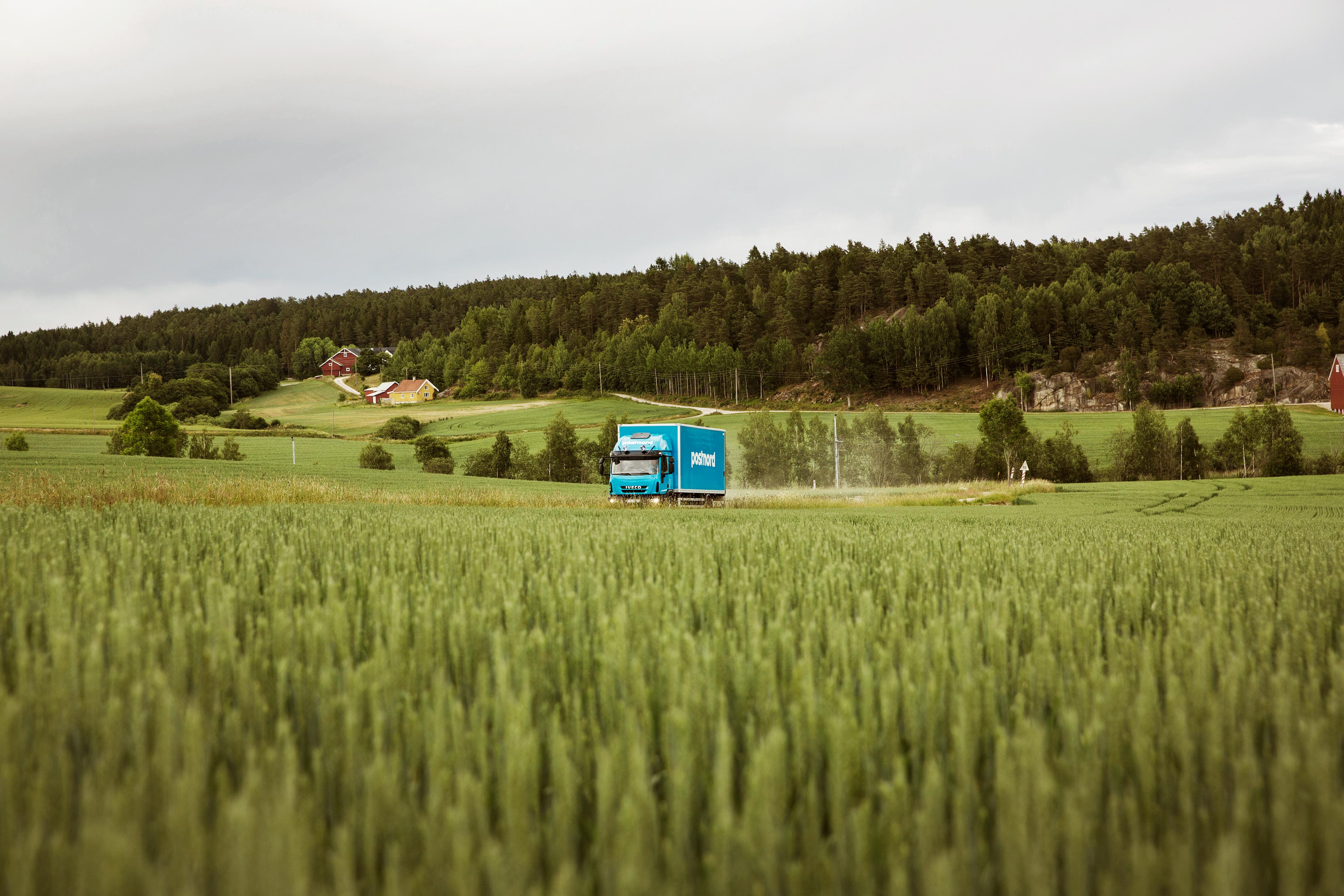 postnord-truck-driving-through-field-landscape.jpg